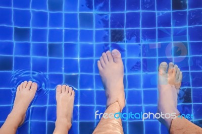 Father And Son Relaxing On The Pool Stock Photo