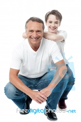 Father And Son Sitting On Floor Stock Photo