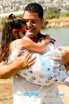 Father Carrying His Daughter Stock Photo