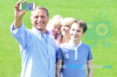 Father Clicking Family Selfie, Outdoors Stock Photo