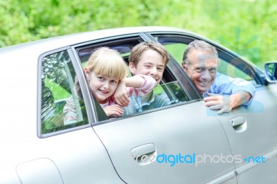 Father Enjoying Car Drive With His Kids Stock Photo