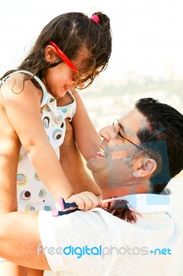 Father Lifting His Daughter Stock Photo