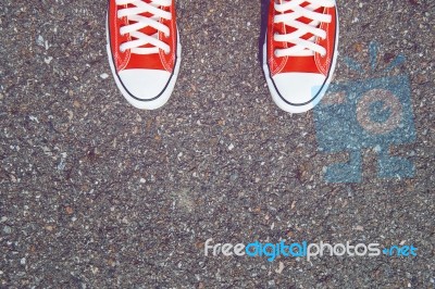 Feet Concept With Red Sneakers On Black Background With Space For Text Or Symbol. Vintage Tone Stock Photo