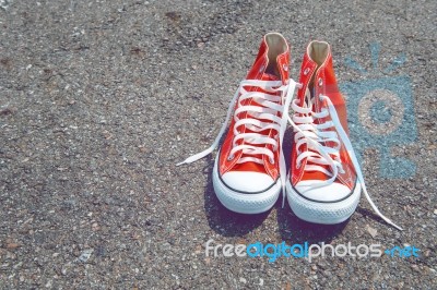 Feet Concept With Red Sneakers On Black Background With Space For Text Or Symbol. Vintage Tone Stock Photo