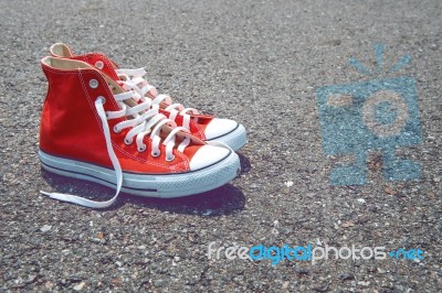 Feet Concept With Red Sneakers On Black Background With Space For Text Or Symbol. Vintage Tone Stock Photo