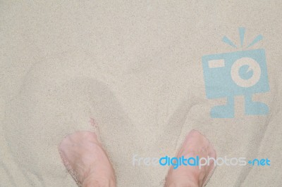 Feet In Sand Stock Photo