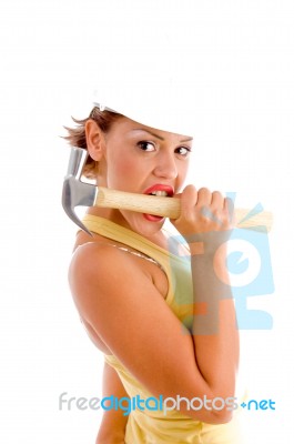 Female Architect Biting Hammer Stock Photo