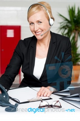 Female Assistant Communicating With Client Stock Photo