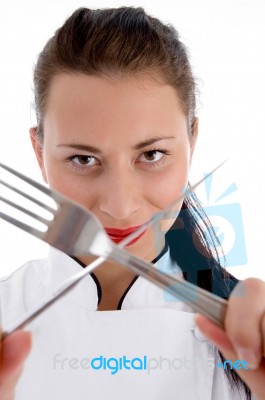 Female Chef Holding Cutlery Stock Photo