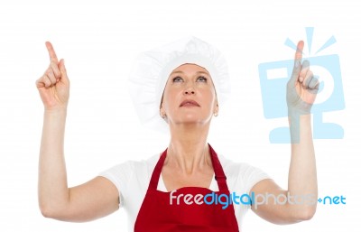 Female Chef Pointing Upwards Stock Photo