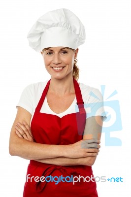 Female Chef Posing With Folded Arms Stock Photo