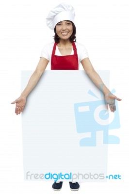 Female Chef Presenting Blank Board Stock Photo