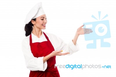 Female Chef Presenting Something Stock Photo