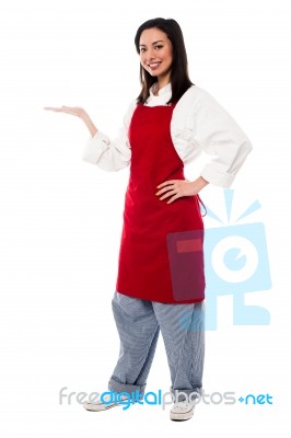 Female Chef Presenting Something Stock Photo