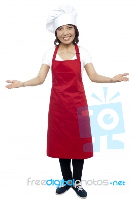 Female Chef Showing Welcome Gesture Stock Photo