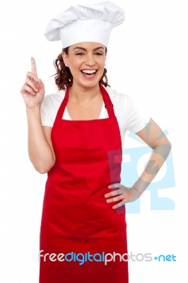 Female Chef with pointing up Stock Photo