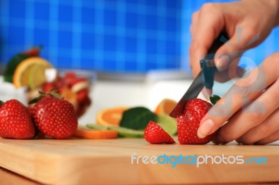 Female Chopping Strawberry Stock Photo