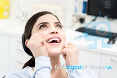 Female Cleaning Her Teeth With  Dental Floss Stock Photo