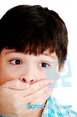 Female Closing Mouth Of Small Boy Stock Photo