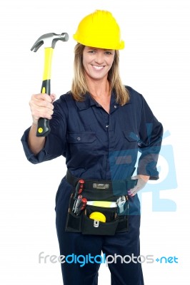 Female Construction Worker Holding Up Hammer Stock Photo