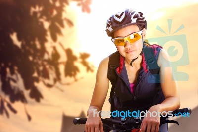 Female Cyclist In Sportswear Riding Bicycle Stock Photo