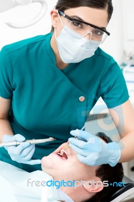 Female Dentist Examines A Patient Stock Photo