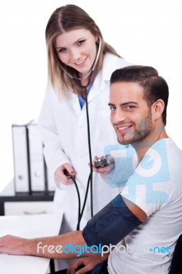 Female Doctor Checking Blood Pressure Stock Photo