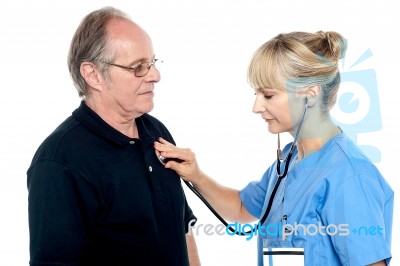 Female Doctor Examining An Elderly Man Stock Photo