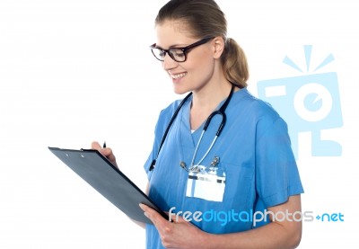 Female Doctor Holding A Clipboard Stock Photo