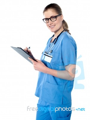 Female Doctor Holding A Clipboard Stock Photo