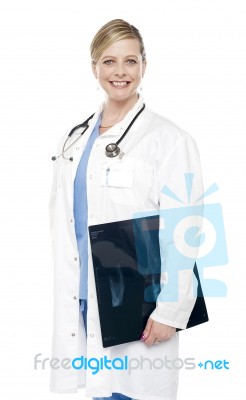 Female Doctor Holding X Ray Report Stock Photo