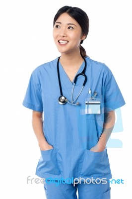 Female Doctor In Uniform Looking Away Stock Photo