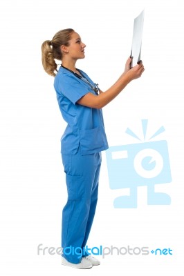 Female Doctor Reviewing Patient's X-ray Report Stock Photo