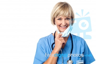 Female Doctor Takes Off His Mask Stock Photo