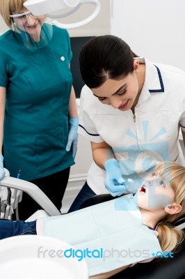 Female Doctor Treating Girl Child Stock Photo