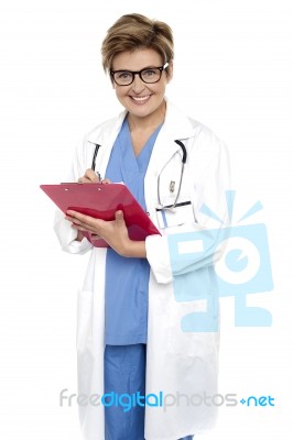 Female Doctor With A Case File In Her Hand Stock Photo