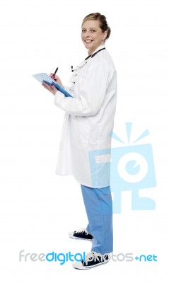 Female Doctor Writing Clipboard Stock Photo