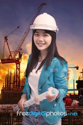 Female Engineer With Construction Plant Against Building Stuctur… Stock Photo