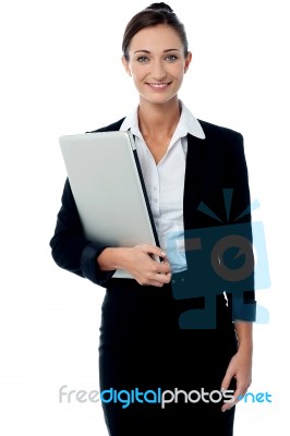 Female Executive Holding Laptop Stock Photo