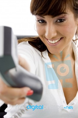 Female giving telephone Receiver Stock Photo