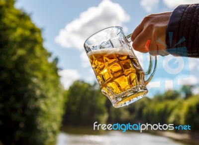 Female Hand Holding A Mug Of Beer Stock Photo