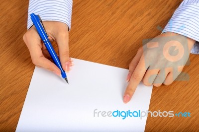 Female Hand Signing Contract Stock Photo