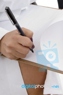 female hand Writing on Clipboard Stock Photo