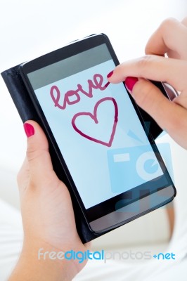 Female Hands Using Her Smartphone At Home Stock Photo