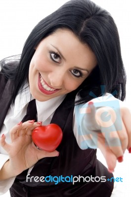 Female Holding A Red Heart Pointing At Camera Stock Photo