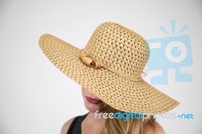 Female In Large Hat Hiding Face Stock Photo