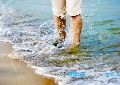 Female Legs With Sea Wave Stock Photo