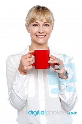 Female Manager Posing With Coffee Mug In Hand Stock Photo