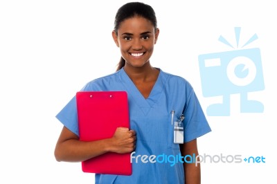 Female Nurse Holding Clipboard, At Duty Stock Photo