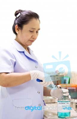 Female Nurse Open Alcohol Bottle Stock Photo